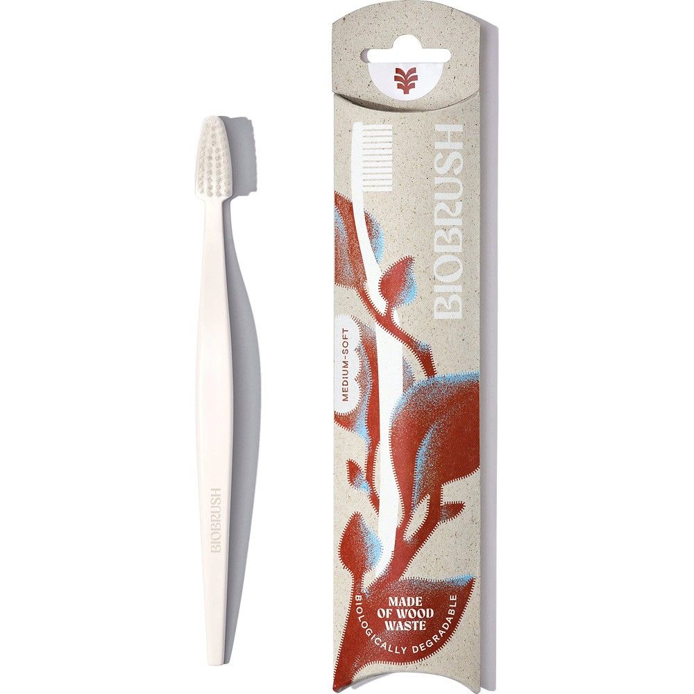 Periuță de dinți Biobrush albă, peri medii moi, din lemn și plastic, ambalaj decorativ.