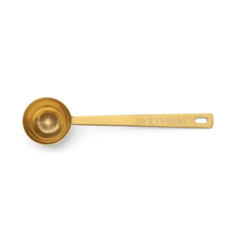 Linguriță aurie Ritual Golden Scoop Ancient și Brave, finisaj metalic lucios, logo gravat.