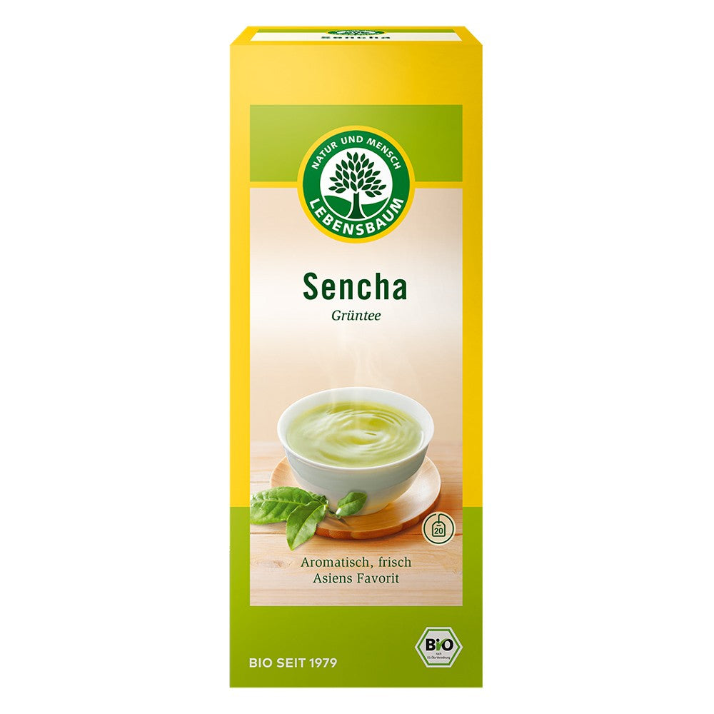 Cutie galbenă de ceai verde Sencha Lebensbaum, design cu frunze și ceașcă.